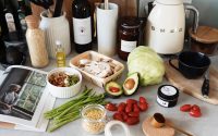 A variety of fresh ingredients and kitchen tools for preparing a healthy meal.